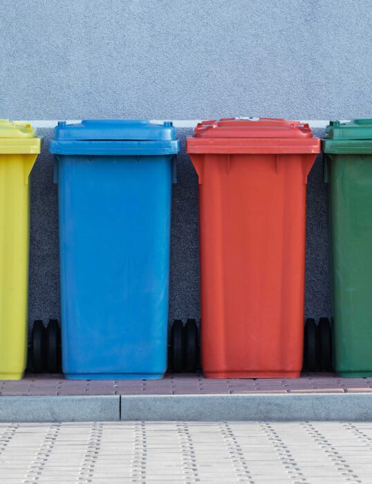 Four different coloured rubbish bins